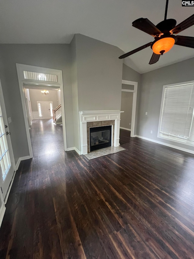 unfurnished living room with lofted ceiling, dark hardwood / wood-style flooring, ceiling fan, and a tile fireplace