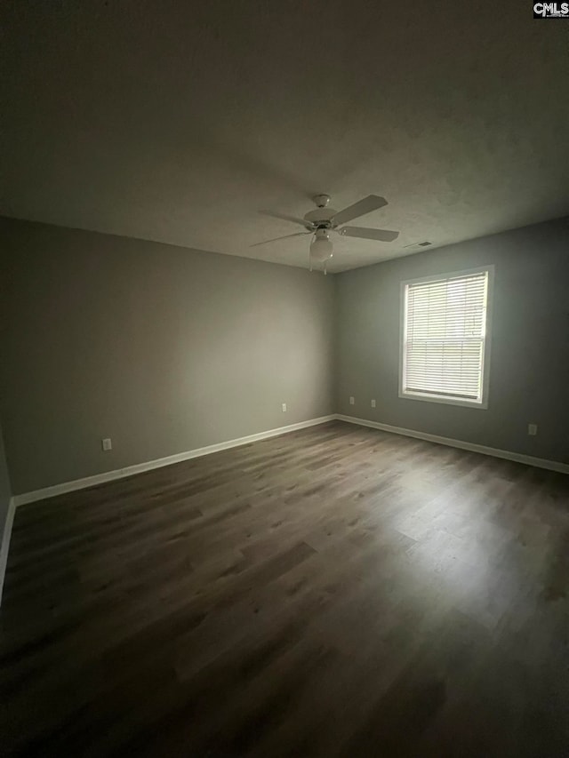 spare room with ceiling fan and dark hardwood / wood-style floors