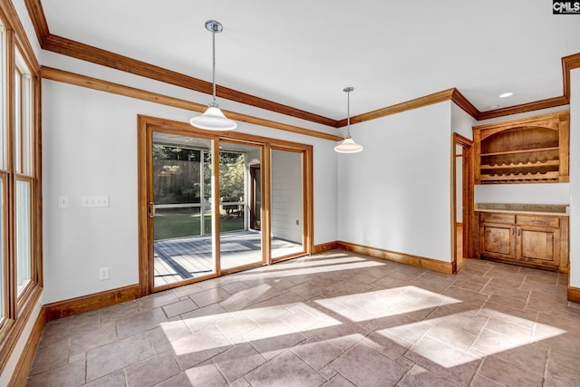 interior space featuring crown molding and plenty of natural light