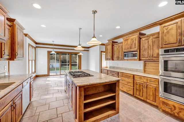 kitchen featuring pendant lighting, crown molding, backsplash, stainless steel appliances, and a kitchen island