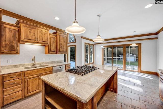 kitchen featuring ornamental molding, a kitchen island, sink, and hanging light fixtures