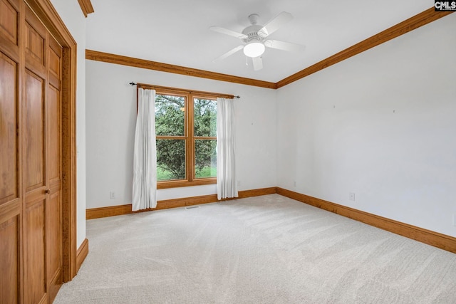 interior space with crown molding, ceiling fan, light carpet, and a closet