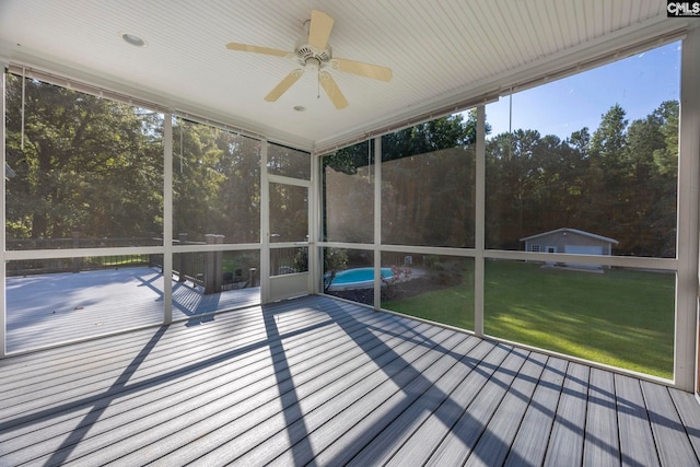 unfurnished sunroom featuring ceiling fan