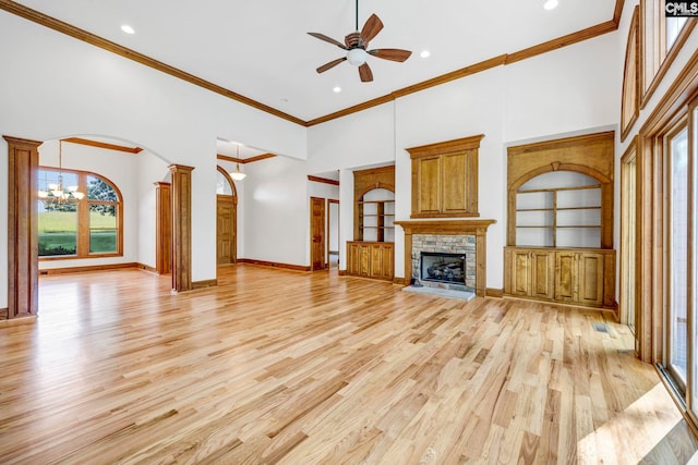 unfurnished living room featuring plenty of natural light, ceiling fan, light hardwood / wood-style flooring, and a fireplace