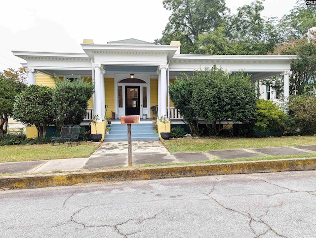 neoclassical home featuring covered porch