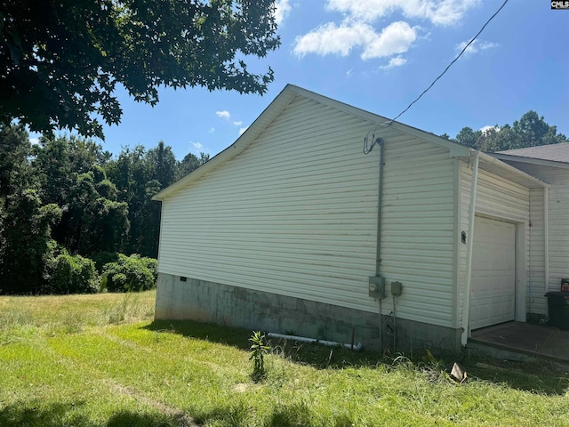 view of property exterior with a garage and a lawn