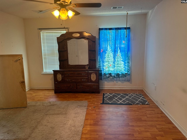 foyer featuring a textured ceiling, hardwood / wood-style floors, and ceiling fan