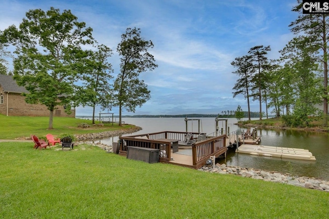 dock area with a water view and a lawn