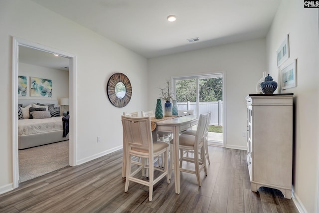 dining space with hardwood / wood-style floors