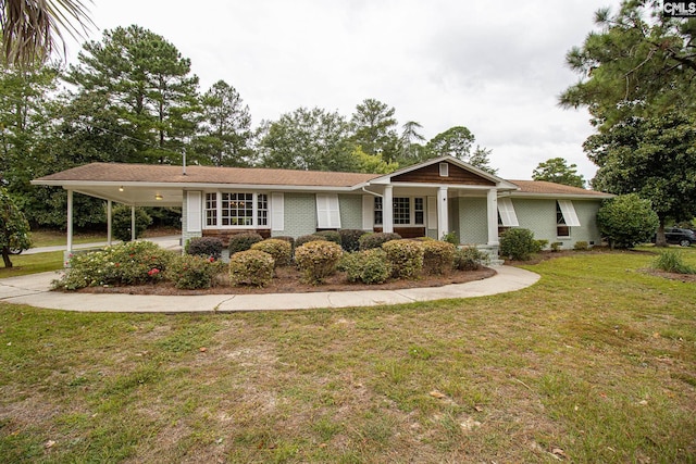 view of front of property featuring a front yard, a carport, and a porch