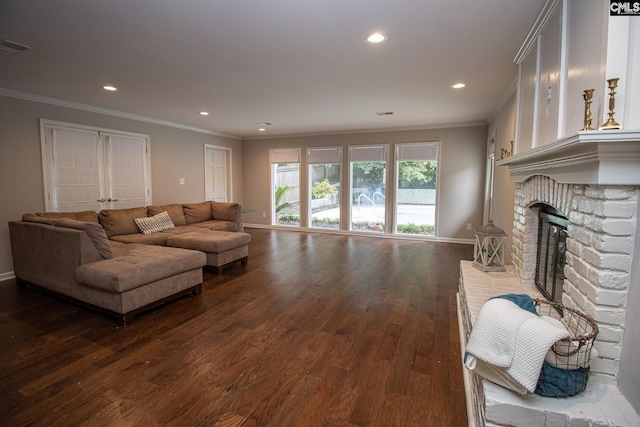 living room with a fireplace, crown molding, and dark hardwood / wood-style floors