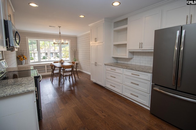 kitchen with white cabinets, stainless steel appliances, and ornamental molding