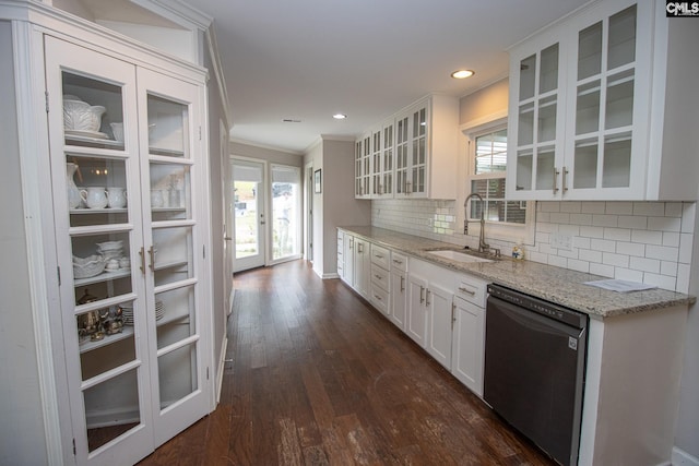 kitchen with a wealth of natural light, dishwasher, sink, and white cabinetry