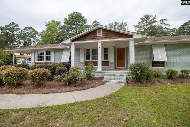 view of front of home with a front yard and a porch