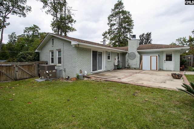 rear view of property with a lawn and a patio