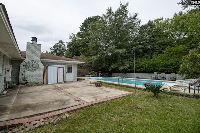 view of swimming pool featuring a yard and a patio