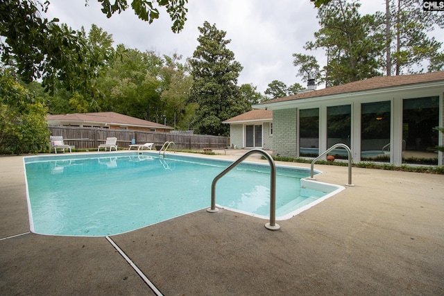 view of swimming pool featuring a patio area