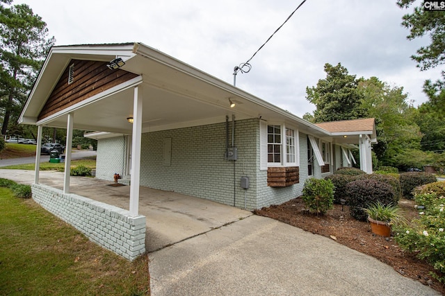 view of side of property with a carport