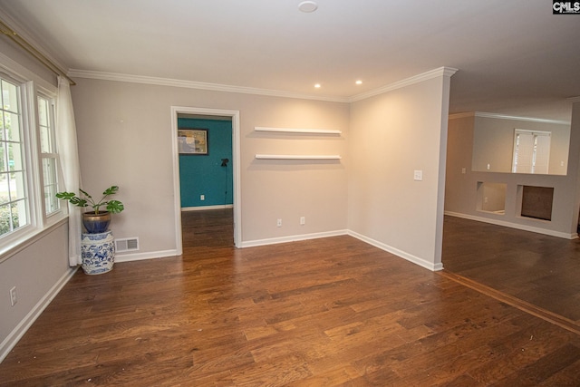 spare room featuring dark hardwood / wood-style flooring and ornamental molding