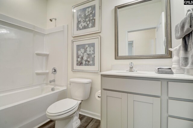 full bathroom featuring vanity, hardwood / wood-style flooring, toilet, and shower / bathtub combination