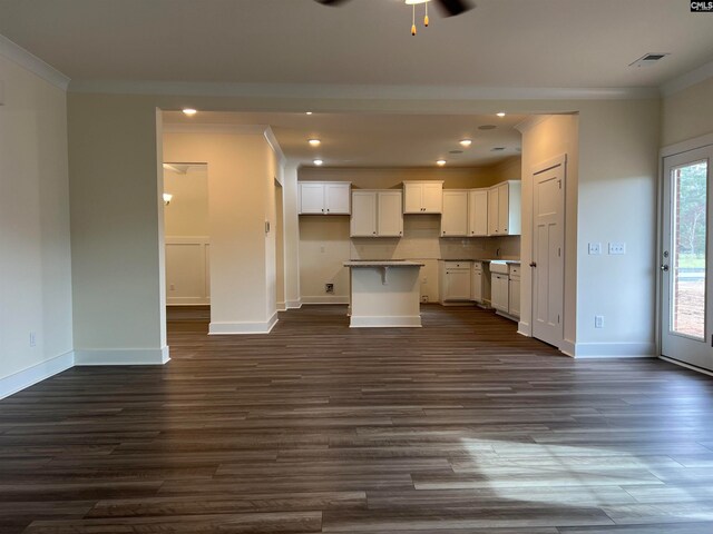 kitchen featuring dark wood-type flooring, white cabinetry, a kitchen island, and ceiling fan