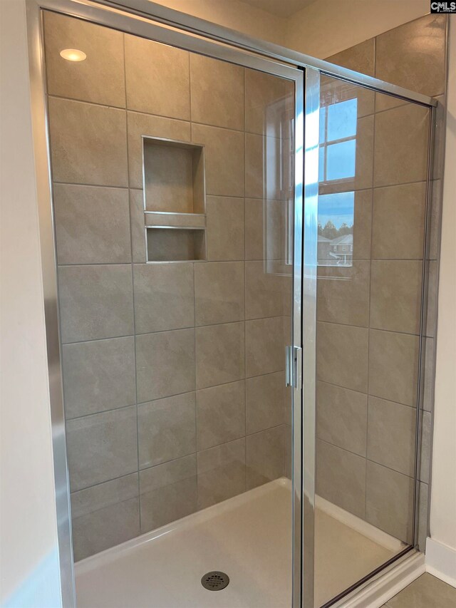 bathroom with a shower with shower door