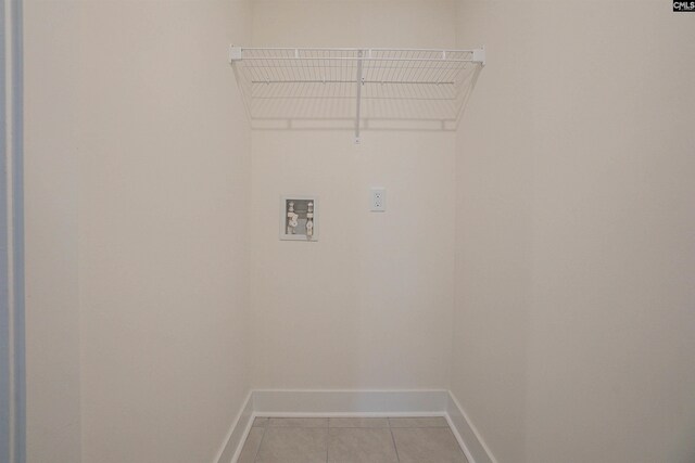 clothes washing area with washer hookup and light tile patterned floors