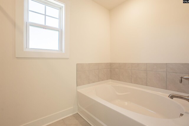 bathroom with tile patterned floors and a bathing tub