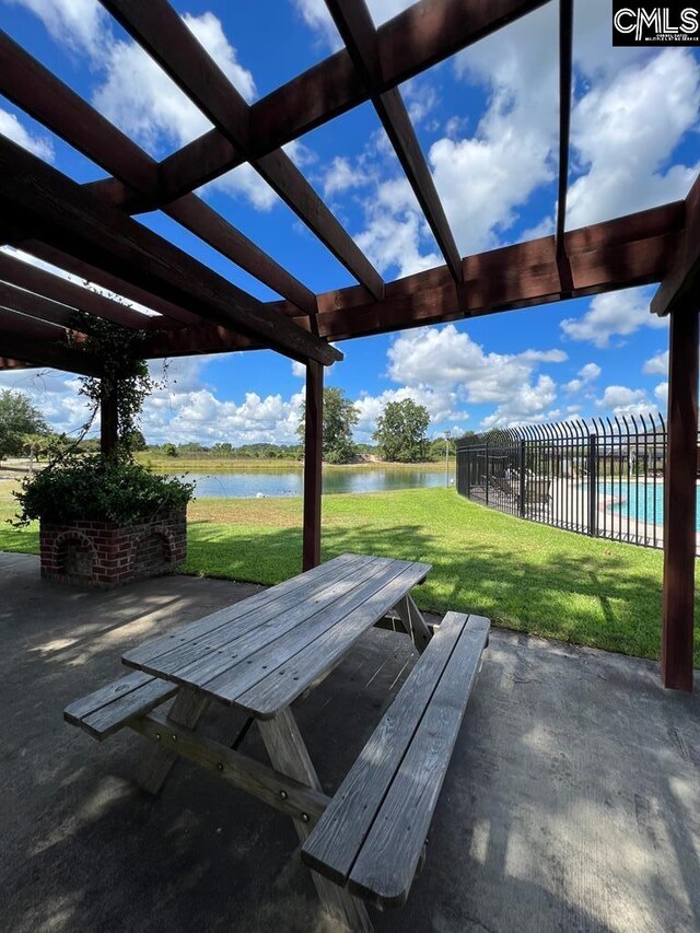 view of patio / terrace with a water view and a pergola