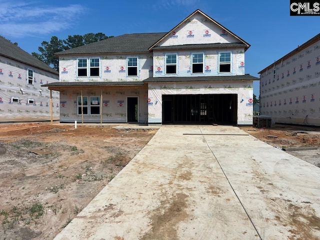 unfinished property featuring a garage and central air condition unit