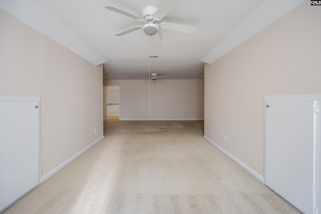 carpeted spare room featuring ceiling fan