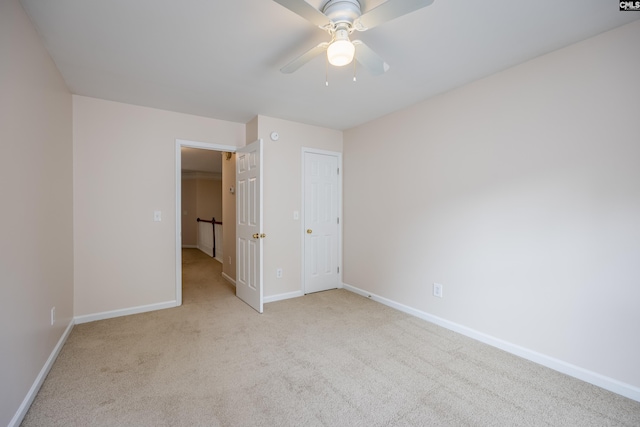 unfurnished bedroom featuring light carpet and ceiling fan