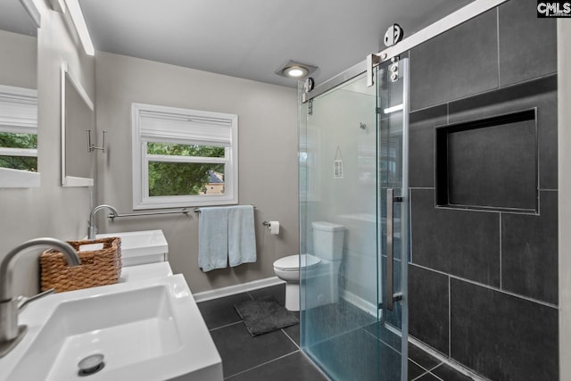 bathroom with walk in shower, vanity, tile patterned flooring, and toilet