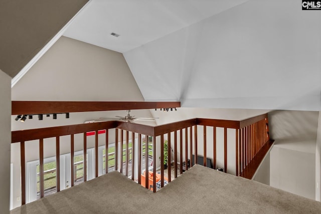 stairway featuring vaulted ceiling and ceiling fan