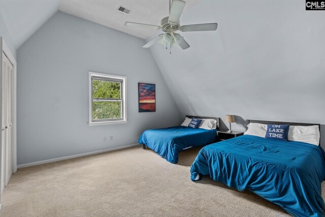 carpeted bedroom featuring lofted ceiling, ceiling fan, and a closet