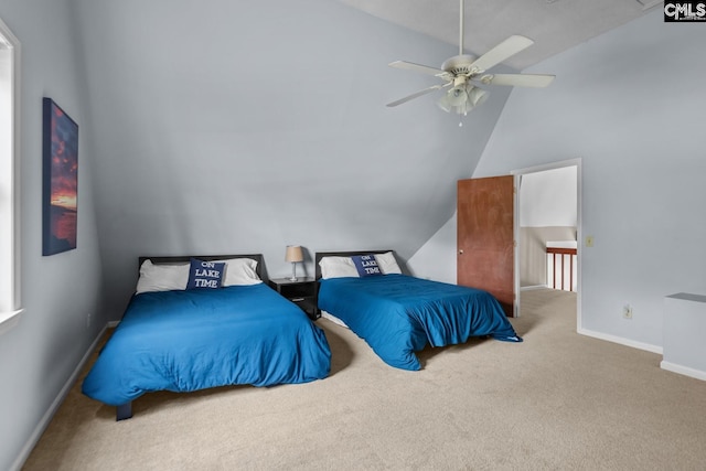 carpeted bedroom with vaulted ceiling and ceiling fan