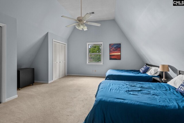 carpeted bedroom with vaulted ceiling, ceiling fan, and a closet