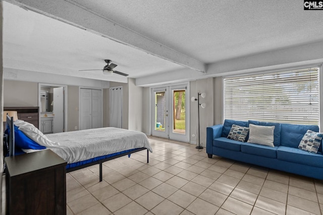 bedroom featuring a textured ceiling, access to outside, light tile patterned floors, and ceiling fan