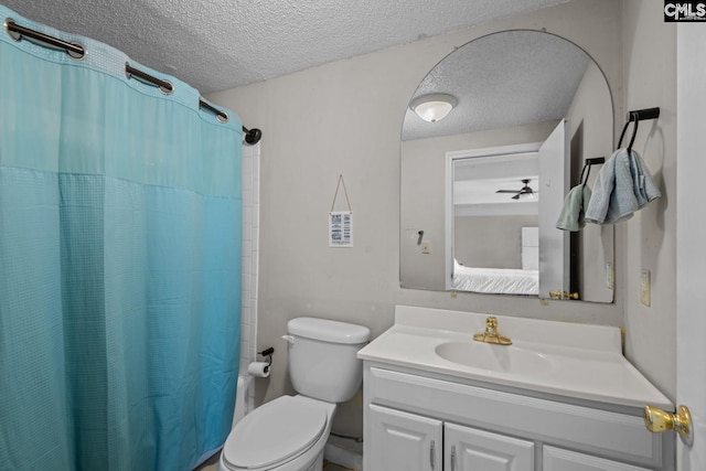 bathroom featuring a textured ceiling, curtained shower, vanity, and toilet