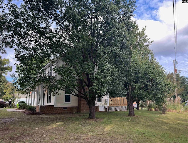 view of side of property with a yard