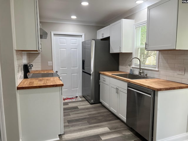 kitchen with white cabinetry, sink, stainless steel appliances, and wooden counters