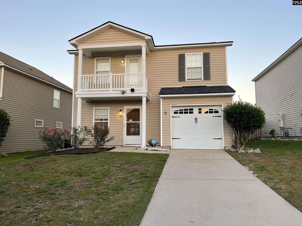 view of front of home with a balcony and a garage