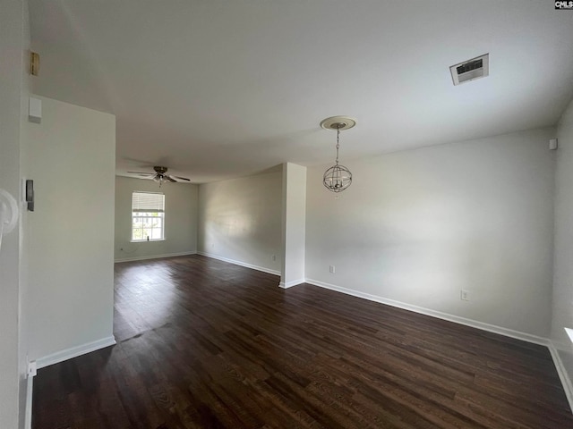 unfurnished room featuring ceiling fan and dark hardwood / wood-style floors