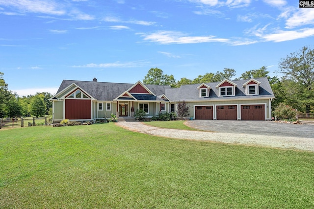 view of front of house with a front yard, a porch, and a garage