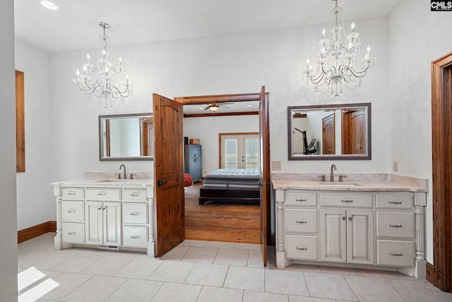 bathroom with vanity, ceiling fan with notable chandelier, and tile patterned flooring