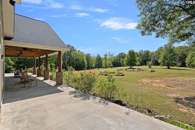 view of yard featuring ceiling fan and a patio area