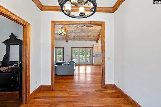 corridor with lofted ceiling with beams, light wood-type flooring, wood ceiling, a notable chandelier, and crown molding