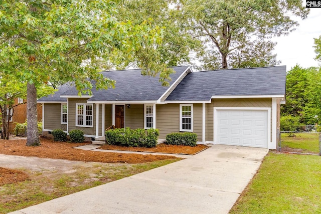 ranch-style house featuring a garage, a front lawn, and a porch