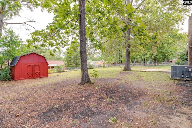 view of yard featuring a storage unit and central AC