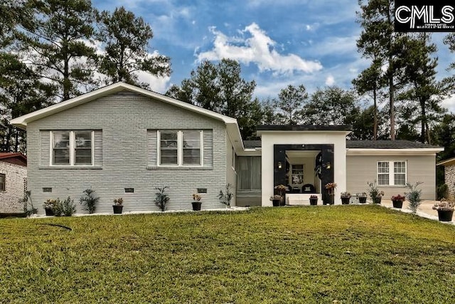 rear view of property with a yard